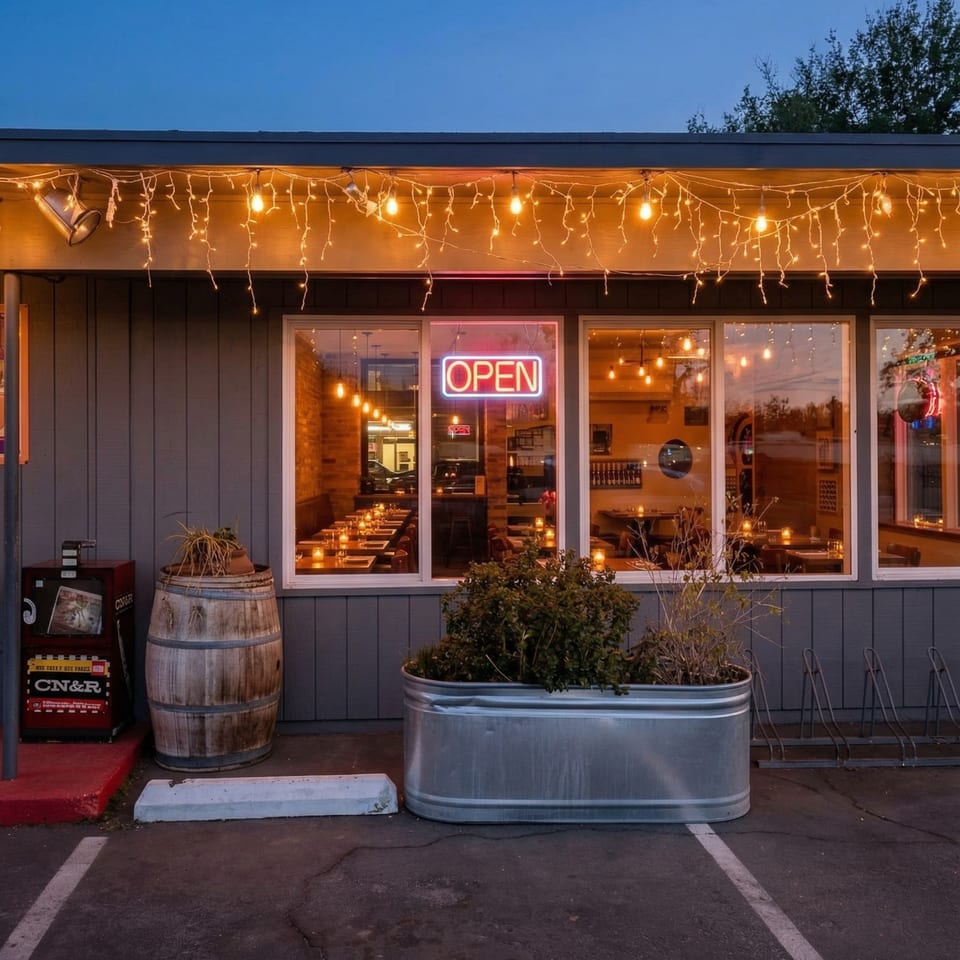 Exterior of Farm Star Pizza at dusk, with an "OPEN" sign glowing in the window.
