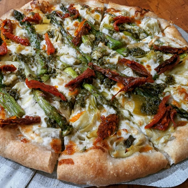 Farm Star Pizza's Italian pizza with pesto, asparagus, sun-dried tomatoes, and artichoke hearts.